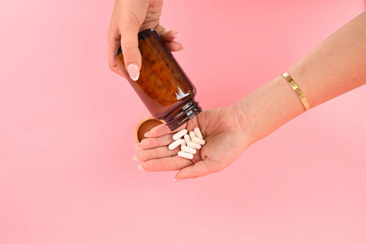 zinc for face skin - close-up of healthy glowing skin with zinc supplement bottle beside it